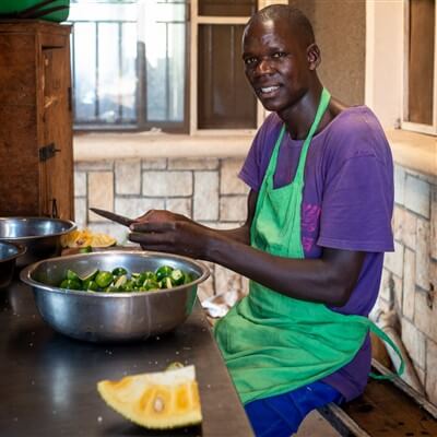 cook-preparing-meal-orphanage-uganda