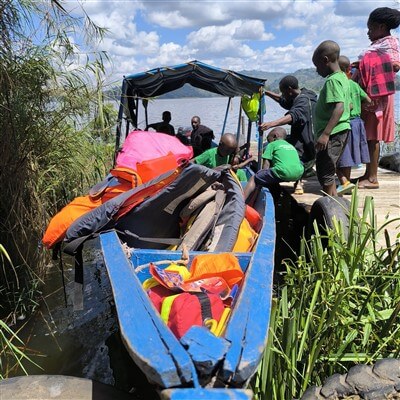 Students take a boat on Lake Bunyonyi in Uganda.