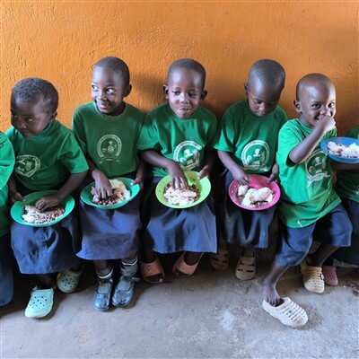 Students are eating in the dining area of Pineapple Project at Lake Bunyonyi in Uganda.